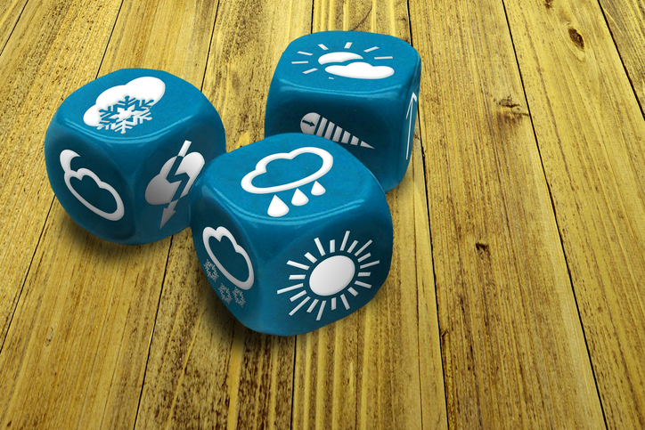 Blue dice showing different weather patterns on each side